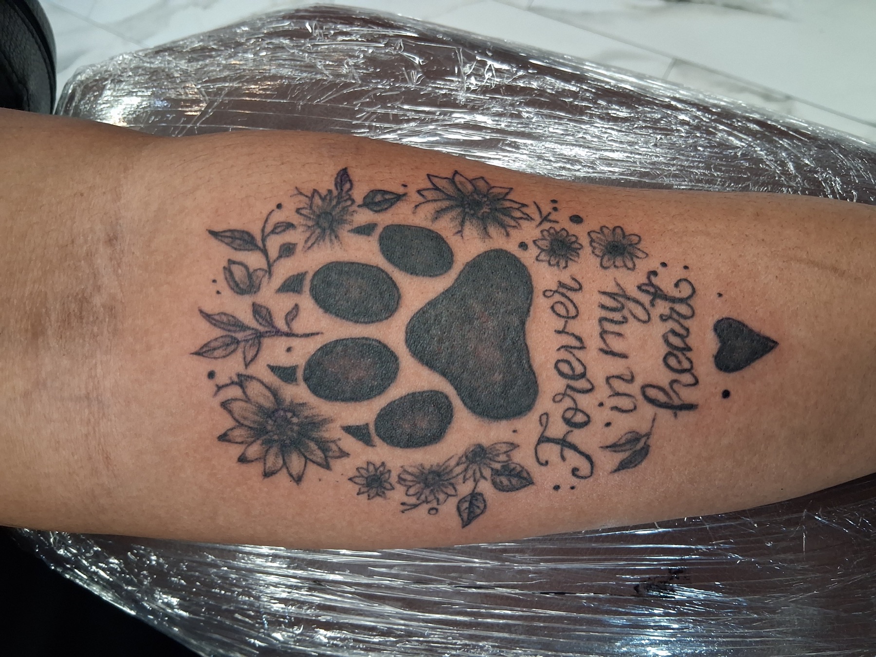 Memorial paw print tattoo by Tony Parisi